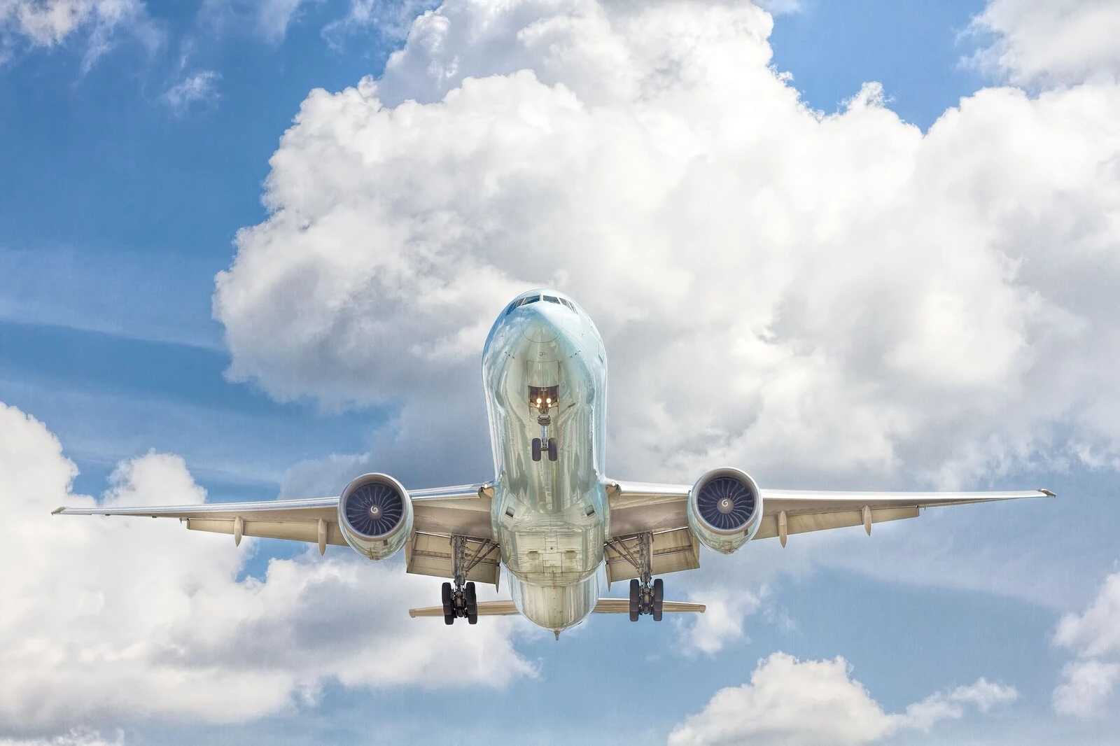 Airliner on approach against a cloudy sky